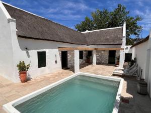 uma casa com uma grande piscina em frente em Yellowwood House em Tulbagh