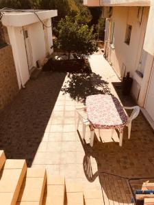 a picnic table on a patio in a courtyard at Country House in Pachia Ammos