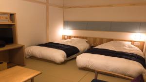 Letto o letti in una camera di Yukairo Kikuya