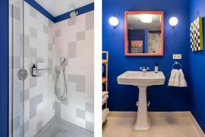 y baño con paredes azules, lavabo y ducha. en CSE San Bernardo, en Sevilla