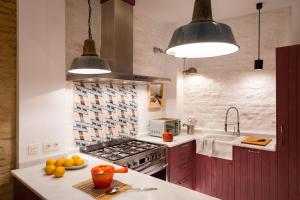 a kitchen with a sink and a stove top oven at CSE San Bernardo in Seville