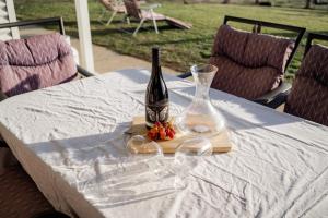 a bottle of wine and glasses on a table at Coorong Island Retreat - Farm Stay at Pet Friendly Property in Meningie +52 photos