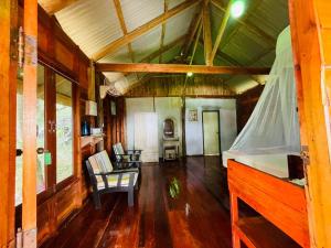 a living room with a bed and a dining room at Kohjum Relax Beach in Ko Jum