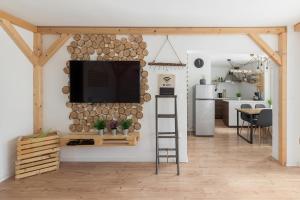 a living room with a flat screen tv on a wall at Apartments Rok in Ljubljana