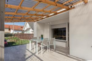 a patio with a table and chairs on it at Apartments Rok in Ljubljana
