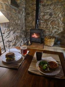 a table with two plates of food and a fireplace at Casa Horno in Robledo