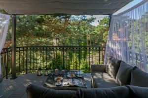 a screened in porch with a couch and a table at Apartamenty In Patio Jurata in Jurata