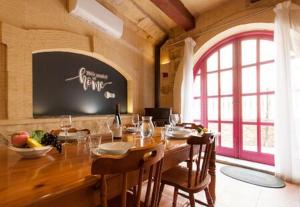 a dining room with a table and a large window at Gozitan Farmhouse Pool & Jacuzzi - PP 2 in Il-Wilġa