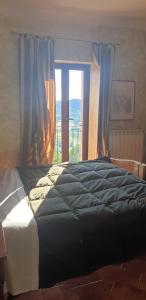 a bedroom with a large bed with a window at Casale Trusella in Ponti