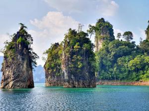 a group of islands in the water with trees at Khao Sok Silver Cliff Resort in Khao Sok