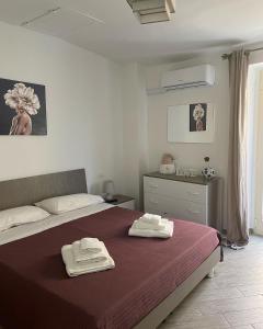 a bedroom with a bed with two towels on it at Sott a 'Sernia in Isernia