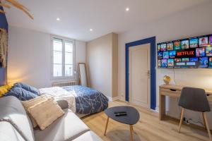 een slaapkamer met een bed en een bureau in een kamer bij Esprit cosy - Welc'Home in Limoges
