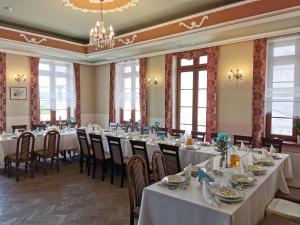 a conference room with tables and chairs and windows at Pałac Koronny Noclegi & Wypoczynek in Wodzisław +27 photos