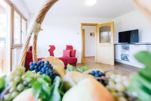 a living room with a bunch of fruit on the floor at Stimpflhof in Aldino