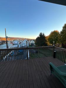 a wooden deck with a bench and a view of a harbor at 4 bedrooms & 2 bathrooms “Dhanu’s place” in Scranton