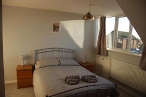 a bedroom with a bed with two pillows on it at Ewe Cottage in Ashbourne