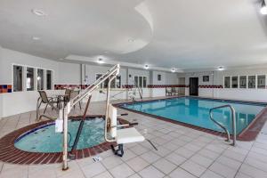 a large swimming pool with a slide in a building at Quality Inn & Suites I-35 E/Walnut Hill in Dallas
