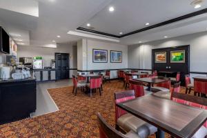 a restaurant with tables and chairs and a cafeteria at Quality Inn & Suites I-35 E-Walnut Hill in Dallas