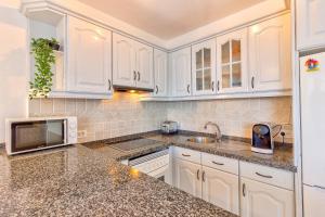 A kitchen or kitchenette at Los Gigantes Amazing Sea view WiFi Pool Parking