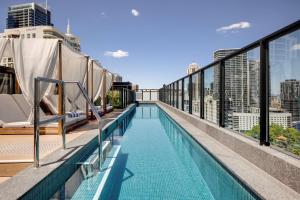 a swimming pool on the roof of a building at Vibe Hotel Sydney Darling Harbour in Sydney
