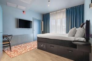 a bedroom with a bed and a table and a tv at Best Western and Hotel Linkoping in Linköping