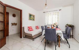 a dining room with a table and a chair at Beautiful Home In Sveti Juraj With Wifi in Sveti Juraj