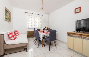 a kitchen and dining room with a table and chairs at Beautiful Home In Sveti Juraj With Wifi in Sveti Juraj
