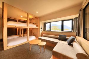 a living room with a couch and bunk beds at Merveille Hakone Gora in Hakone