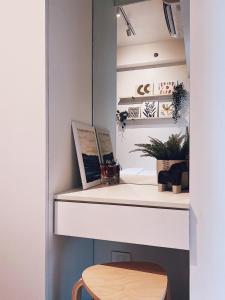 a desk with a wooden stool in a room at Makati Cosy Home l Couples Families l 500Mbps Wifi in Manila +9 photos
