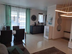 a living room with a table and a kitchen at Apartament -Sweet Home in Lubin