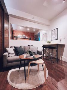 a living room with a couch and a table at Makati Cosy Home l Couples Families l 500Mbps Wifi in Manila