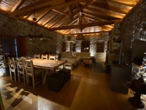 ein großes Wohnzimmer mit einem Holztisch und Stühlen in der Unterkunft Villa Ardamis Karyes in Karyes