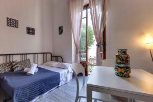 a bedroom with a bed and a table with a vase on it at Sleep Tight Florence Apartment in Florence