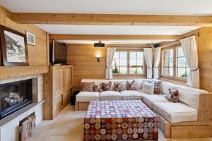 a living room with a couch and a fireplace at Chalet Lo Villâzo by Mrs Miggins in Grimentz