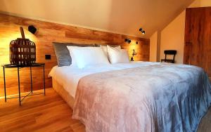 a bedroom with a large bed with a wooden wall at KOKICHE 4 Friends, Borovets in Borovets