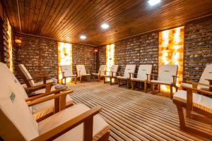 a row of chairs in a room with brick walls at Fiald Hotel & Spa in Bacău