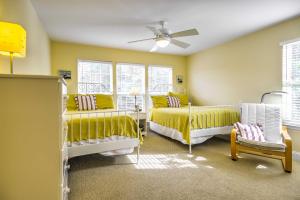 a bedroom with two beds and a ceiling fan at Bethany Beach House 750 Feet from Ocean! in Bethany Beach