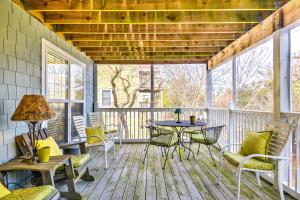 a screened in porch with a table and chairs at Bethany Beach House 750 Feet from Ocean! in Bethany Beach