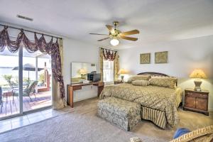 a bedroom with a bed and a ceiling fan at Gloucester Retreat with Backyard Oasis and Pier! in Gloucester