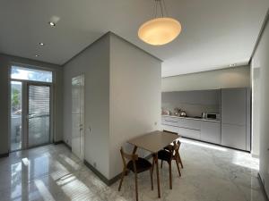 a kitchen with a table and chairs in a room at Central Park apartment in Baku