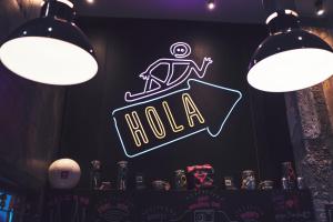 a neon sign in a bar with a man on a sushi at Generator Barcelona in Barcelona +33 photos