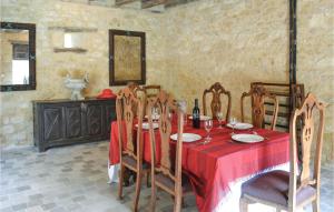 a dining room with a table with a red table cloth at Nice Home In Domme With Wifi in Domme