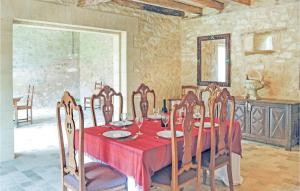 a dining room with a red table and chairs at Nice Home In Domme With Wifi in Domme