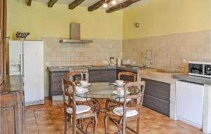 a kitchen with a table and chairs in it at Nice Home In Domme With Wifi in Domme