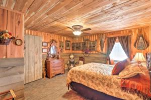 a bedroom with a bed in a room with wooden walls at Quiet, Historic Manor Located in Ghost Town! in Calico Rock