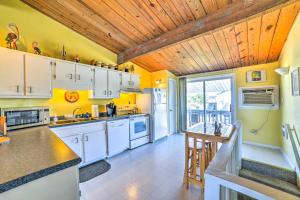 a kitchen with white cabinets and a wooden ceiling at Coastal Atlantic Beach Duplex Less Than 1 Mi to Boardwalk! in Atlantic Beach