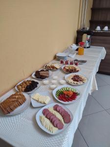 a table with many plates of food on it at Silk Way Boutique Hotel in Osh