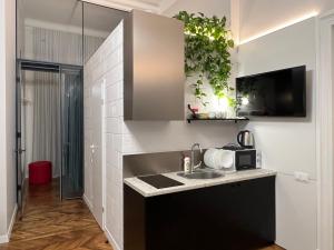 a kitchen with a sink and a microwave at The Heart of Lviv Apartments - Lviv in Lviv