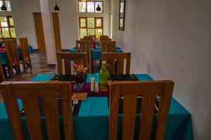 a dining room with a blue table and chairs at Chalet Seabuckthorn - Hunder in Hundar