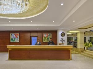 two people sitting at a reception desk in a lobby at Fortune Park, Katra - Member ITC's Hotel Group in Katra